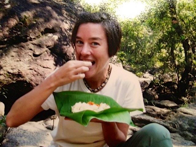 Katherine eating from a leaf while living at an ashram in Southern India and studying yoga and ayurveda